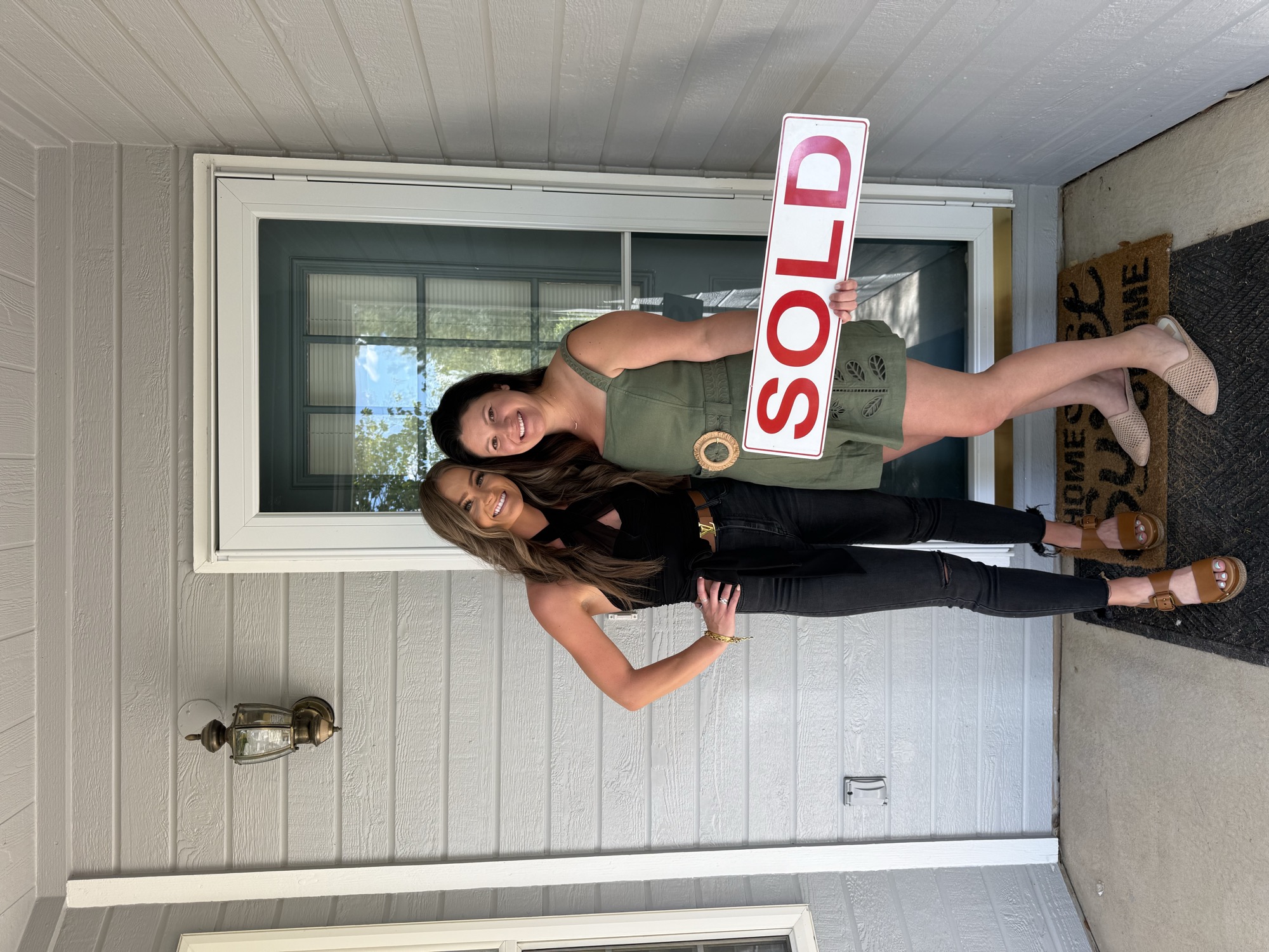 Makura with a client beside a SOLD sign