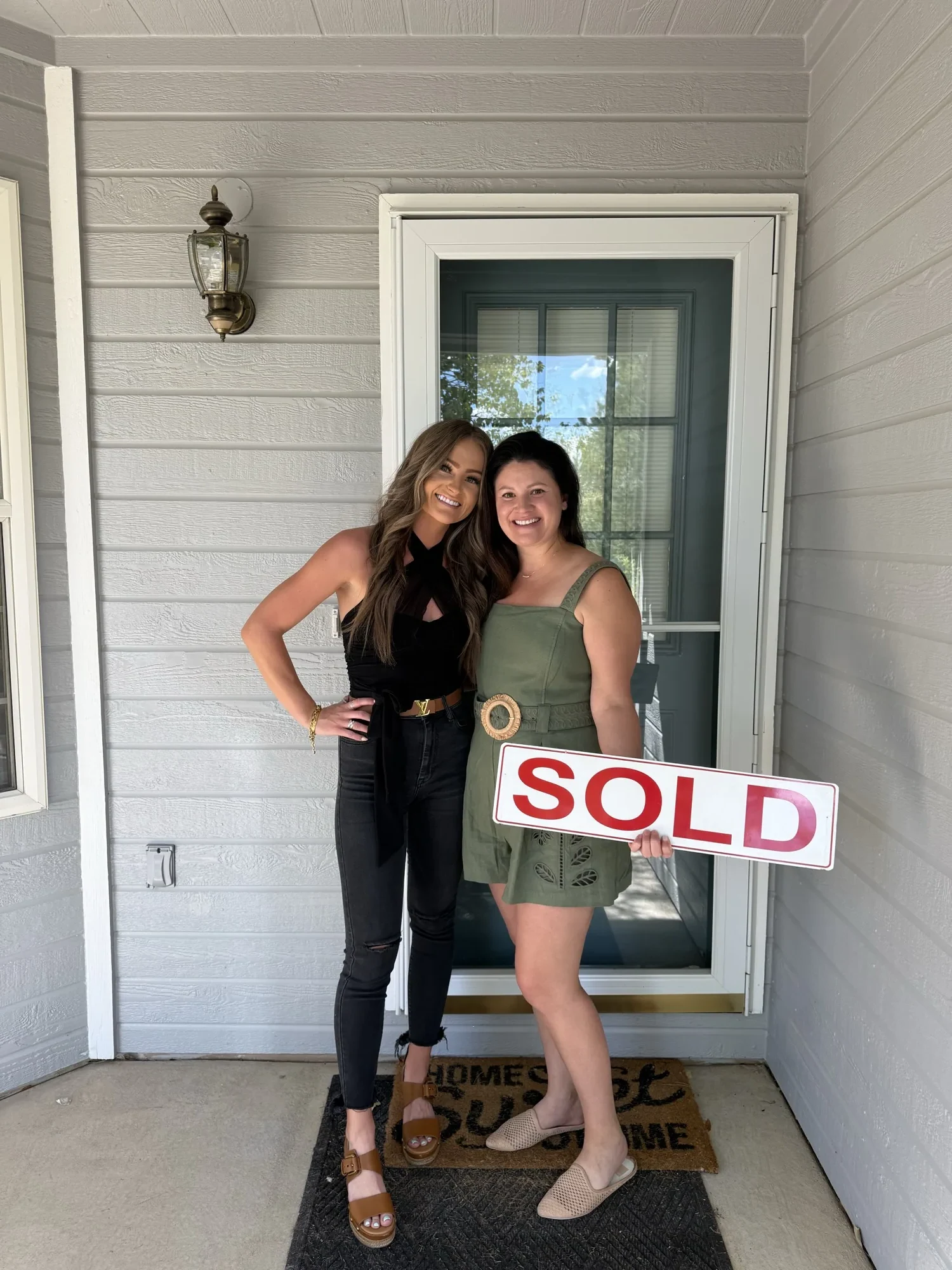 Makura with a client beside a SOLD sign